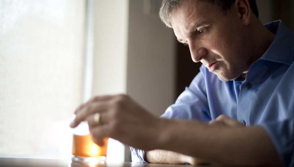 man with a glass of alcohol