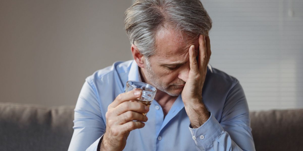 man with a glass of alcohol
